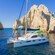 A catamaran docked close to El Arco land formation in Los Cabos, Mexico